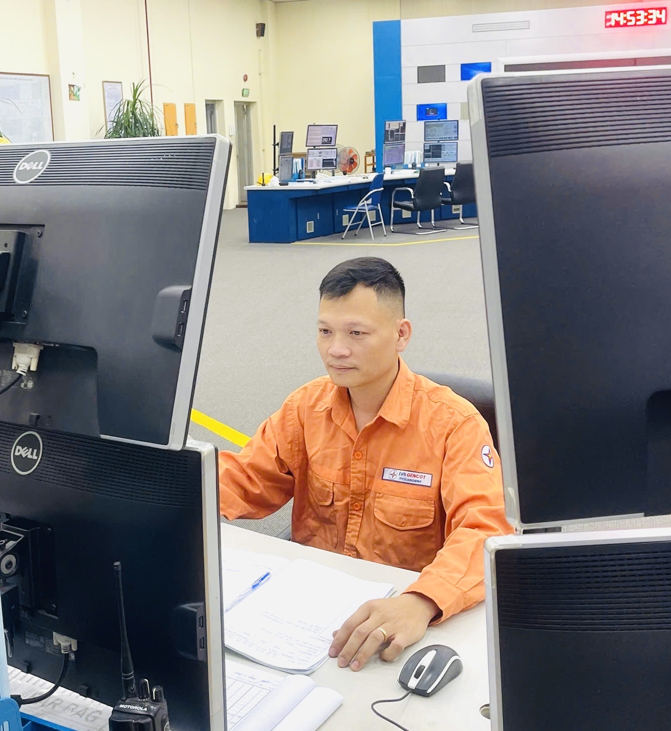 A person sitting at a desk with several computer screensAI-generated content may be incorrect.