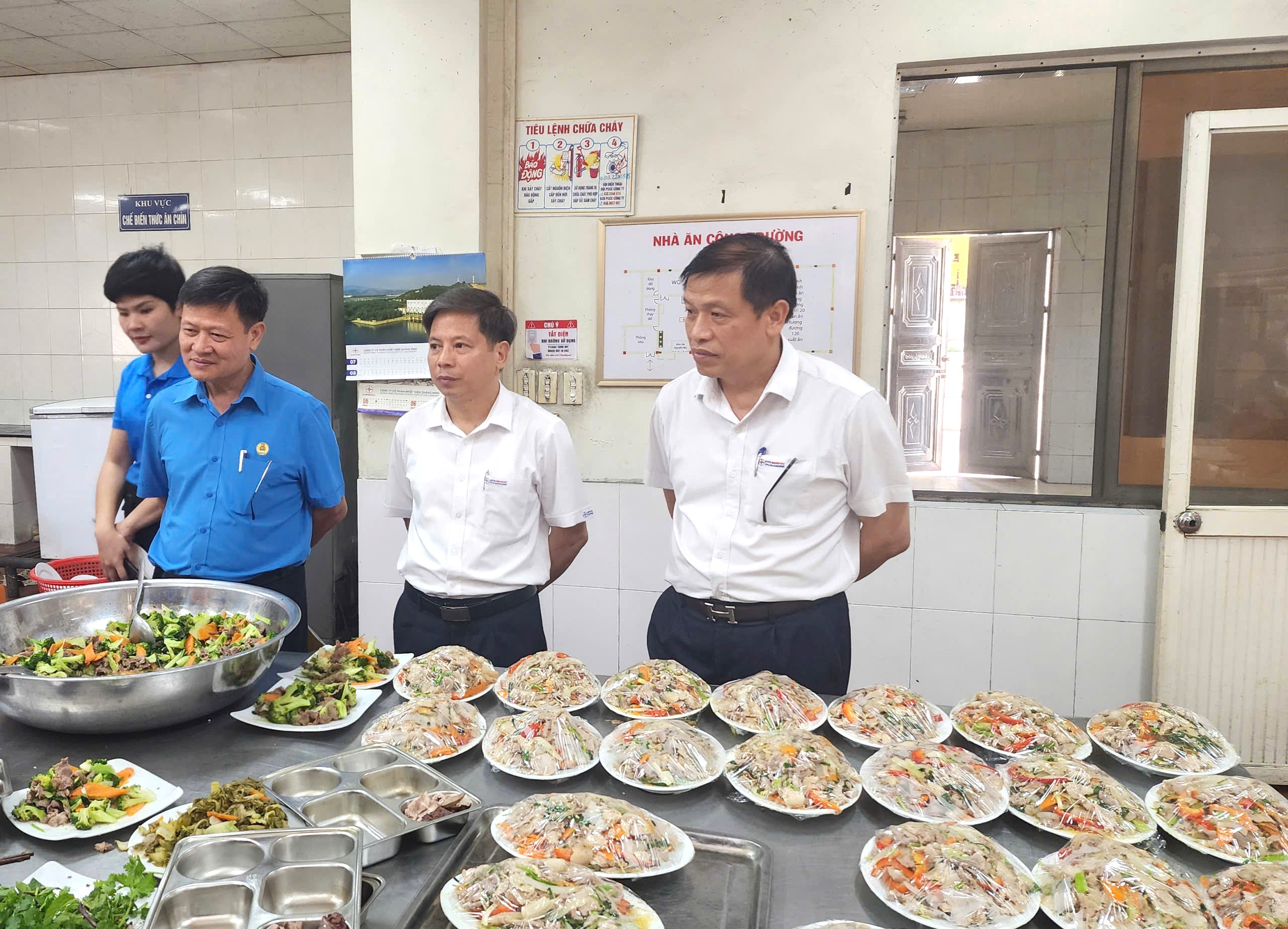 A group of men standing around a table full of foodAI-generated content may be incorrect.